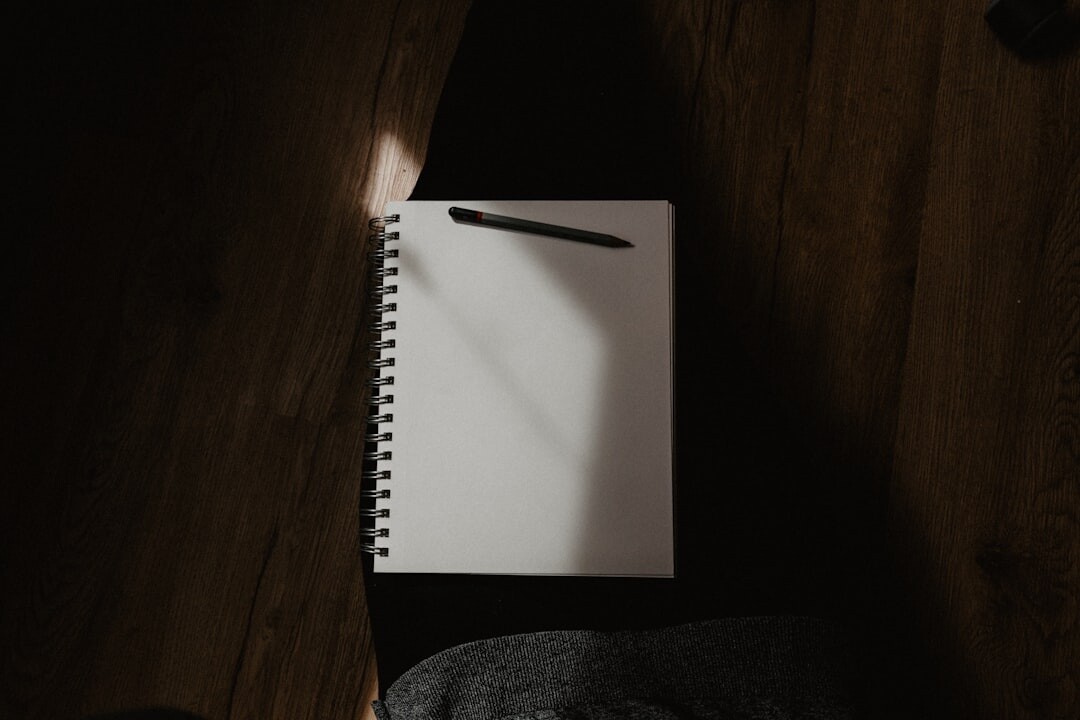 Journalist writing interview questions in a notebook