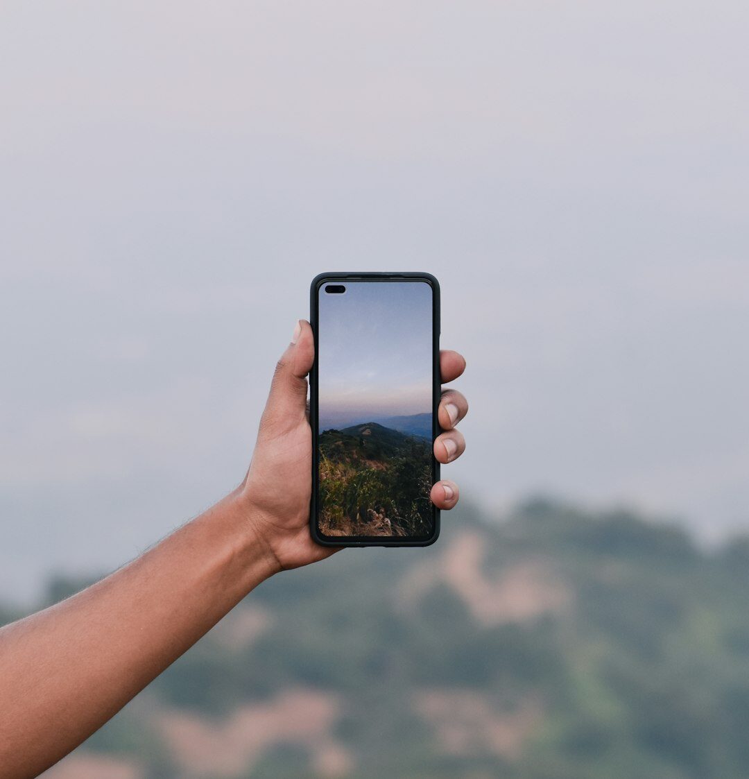 Hands holding a smartphone displaying a vertical video edit