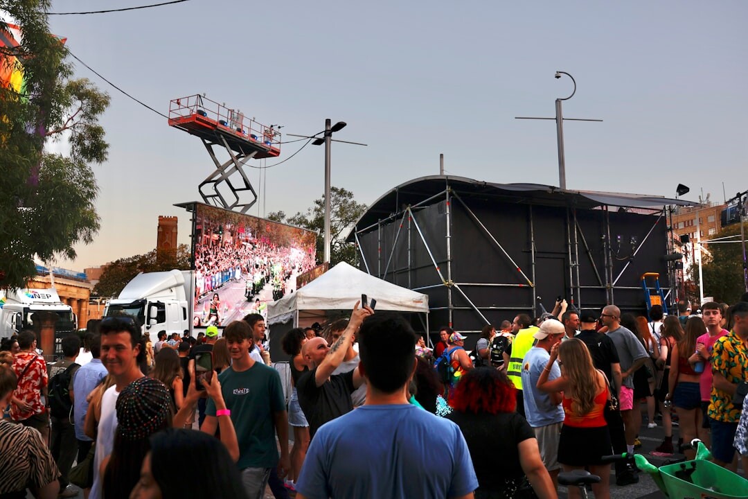 Video crew filming a crowd at an outdoor cultural festival
